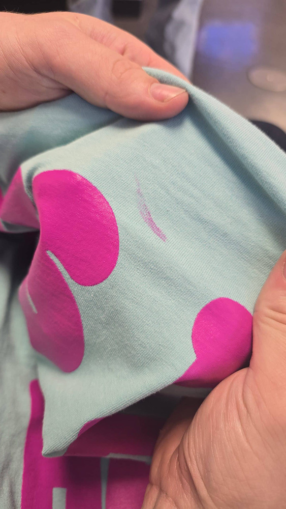 Accidental ink smear on garment from handling